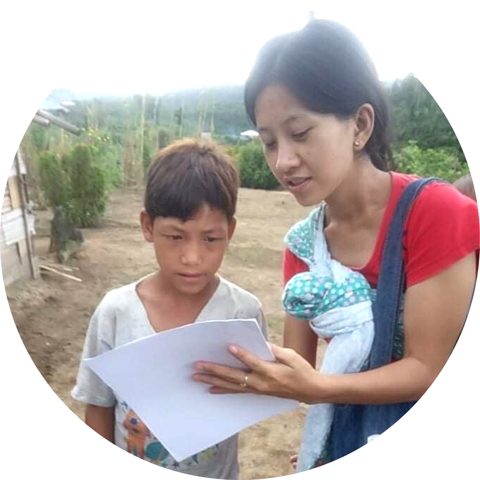 Myanmar teacher helps student.